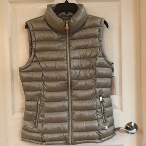 New puffer sleeves less jacket, never worn. Brand Calvin Klein, size L.